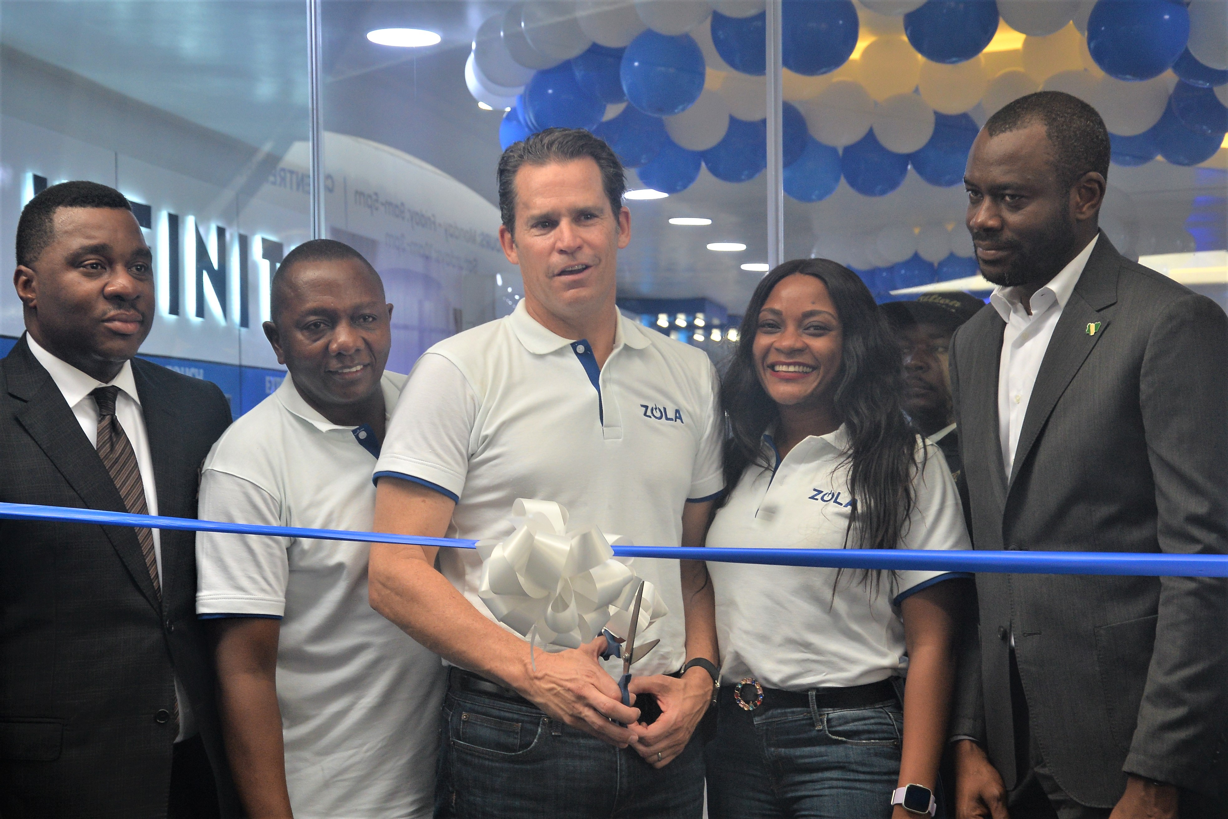 Bill Lenihan, center, with ZOLA colleagues and partners at the Ikoyi Experience Centre ribbon cutting