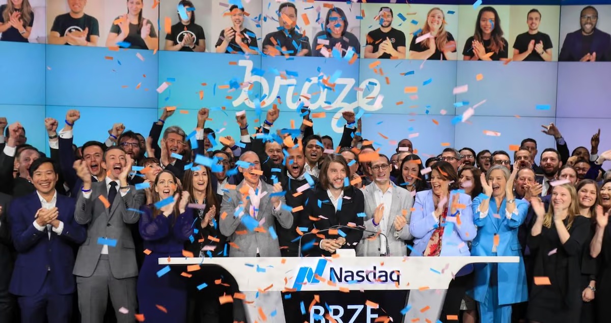 Bill Magnuson and the Braze team celebrating at Nasdaq amid blue and orange confetti