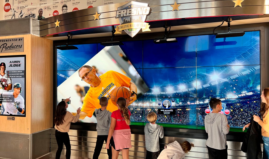Visitors explore interactive displays at the Fresno County Athletic Hall of Fame
