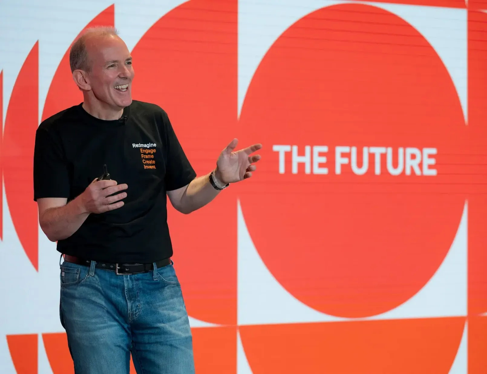 BILL founder René Lacerte speaking onstage in front of an orange graphic reading The Future