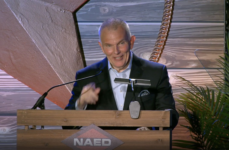 Bill Waltz speaking behind an NAED lectern at an industry awards event