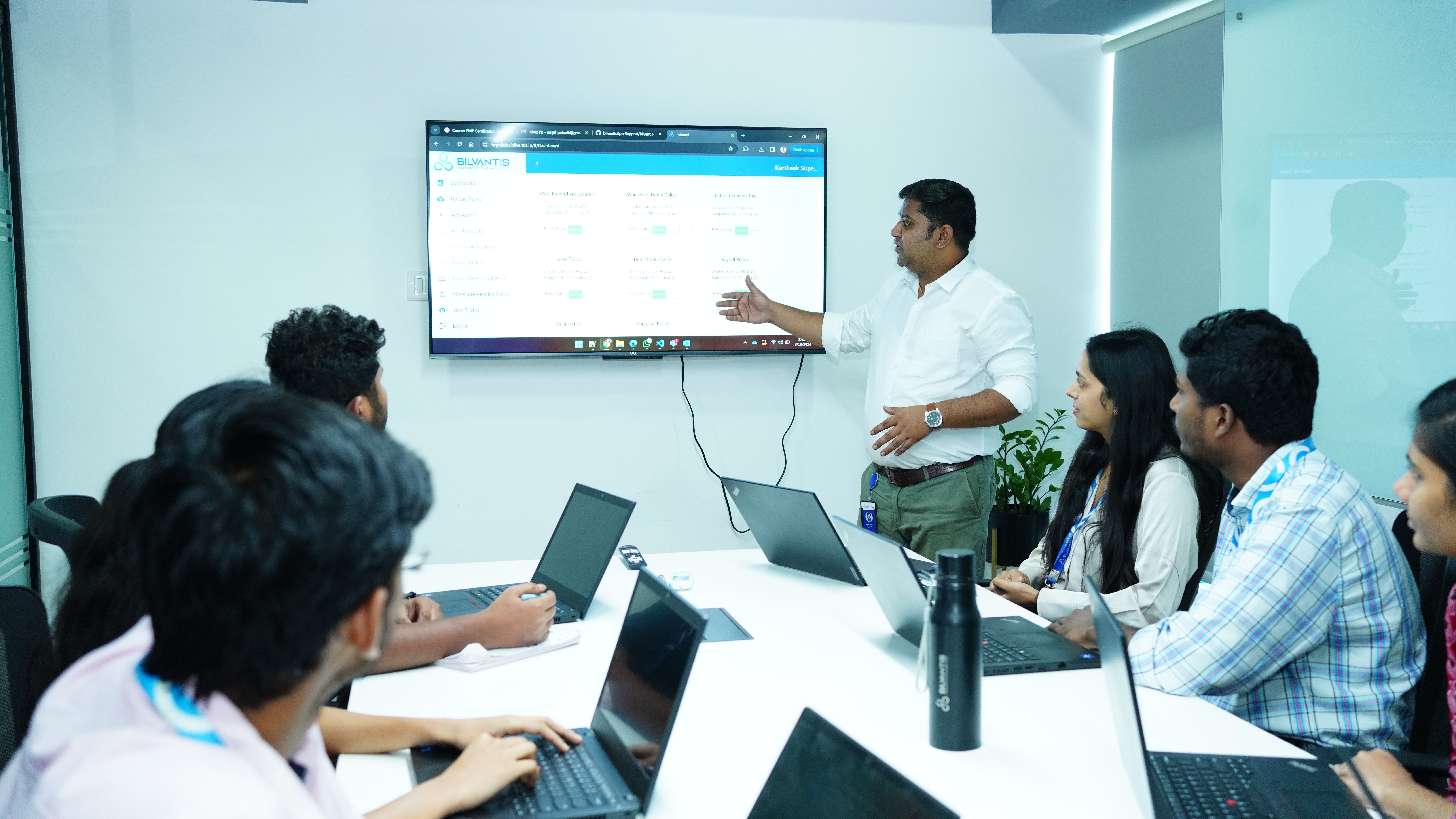 Bilvantis colleagues seated around a conference table during a presentation