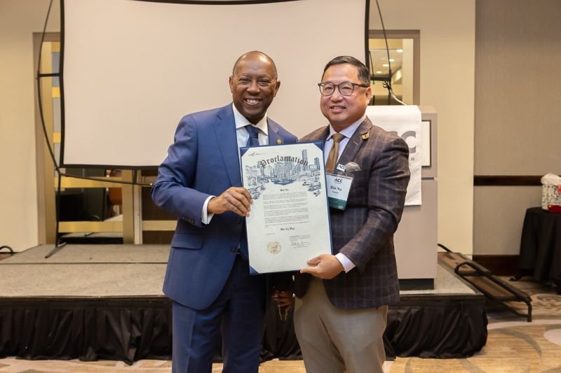 Sylvester Turner and Bin Yu hold a Houston proclamation together