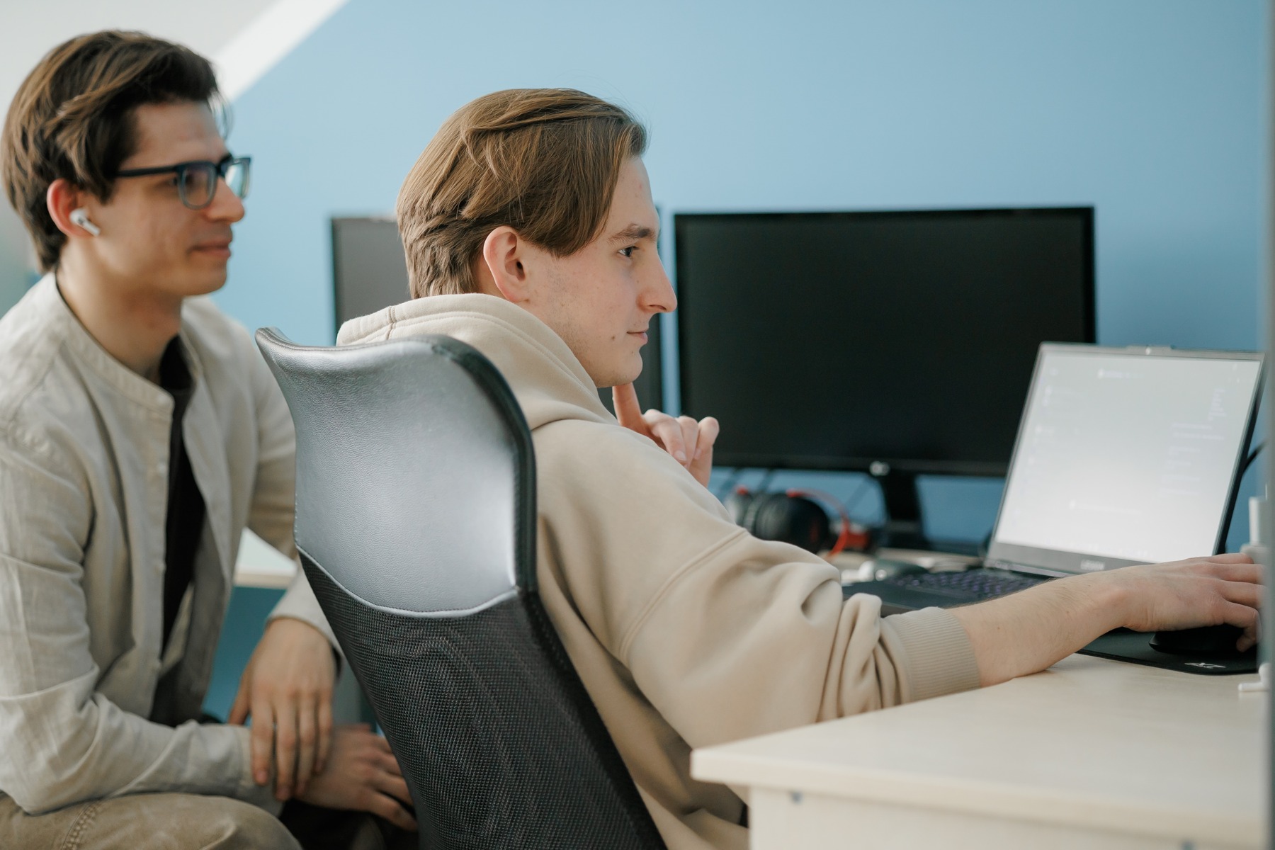 Two Binariks colleagues working together at a laptop in the office