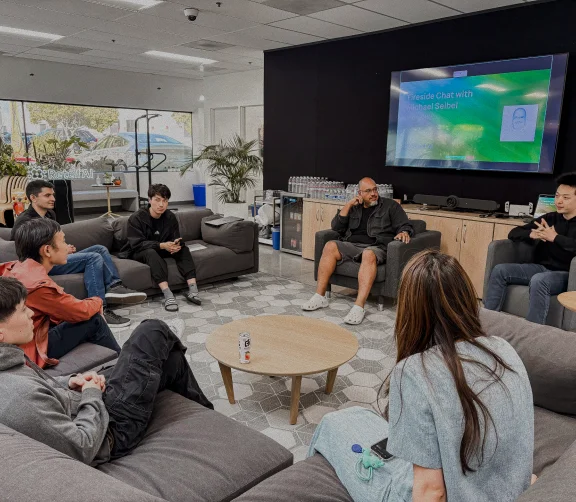 Retell team members seated around a table for a fireside conversation with Michael Seibel