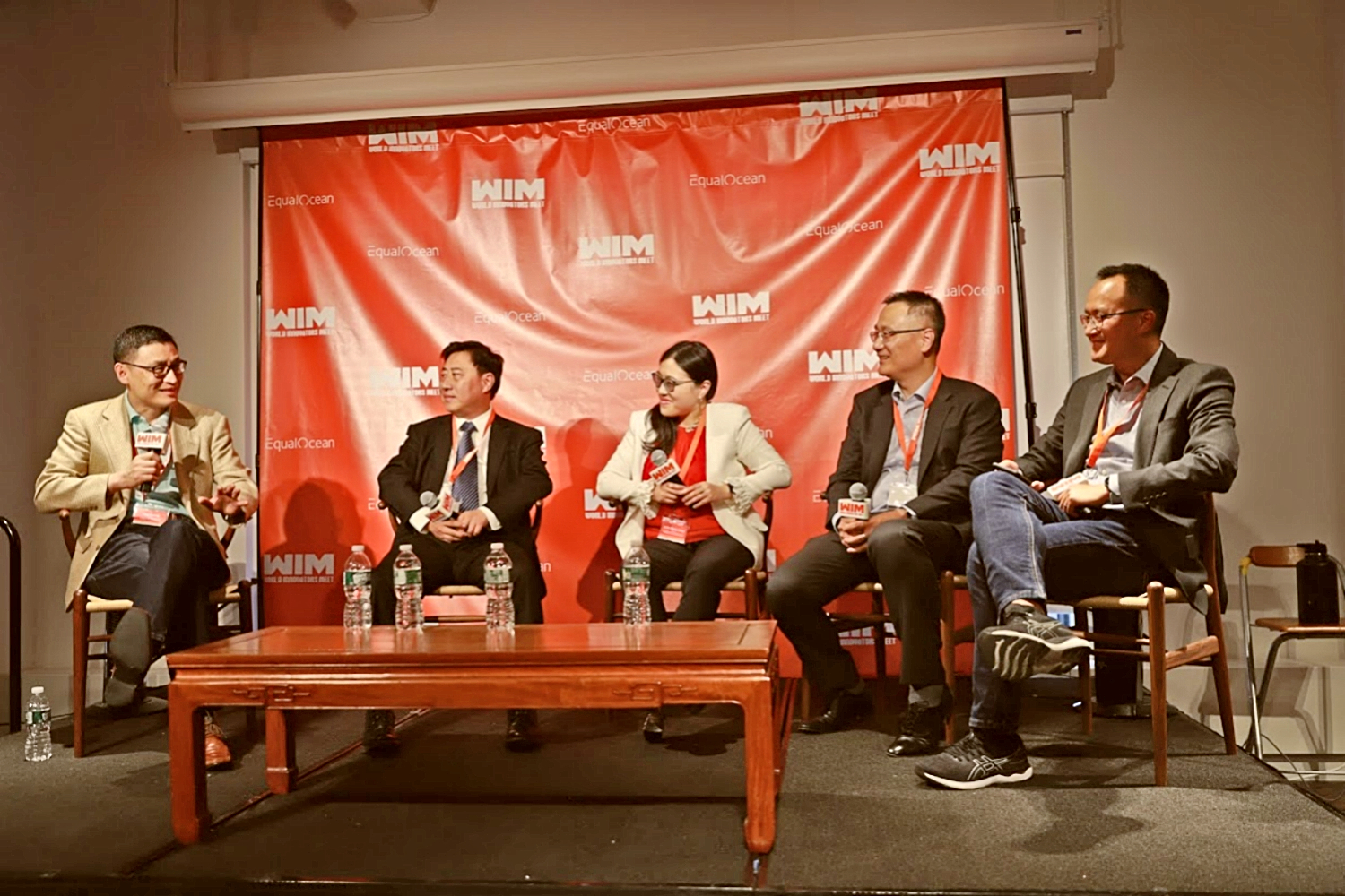 Bing Yuan, at far right, seated with four fellow participants on the World Innovators Meet stage in New York
