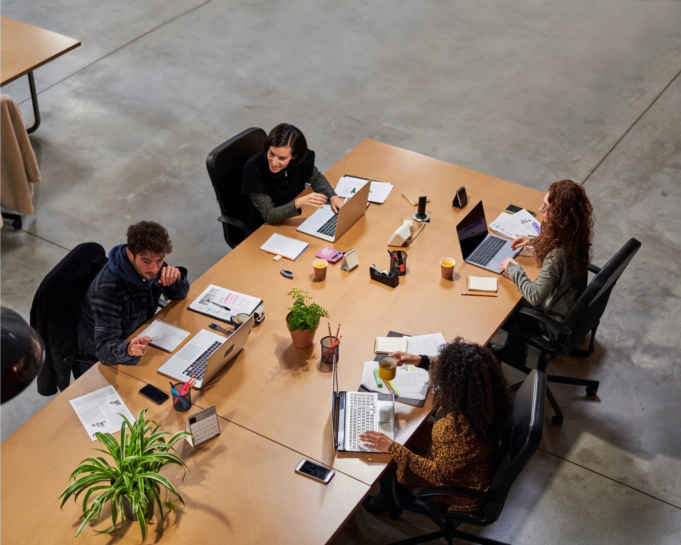 People collaborate around a meeting table in a Biofourmis careers photograph