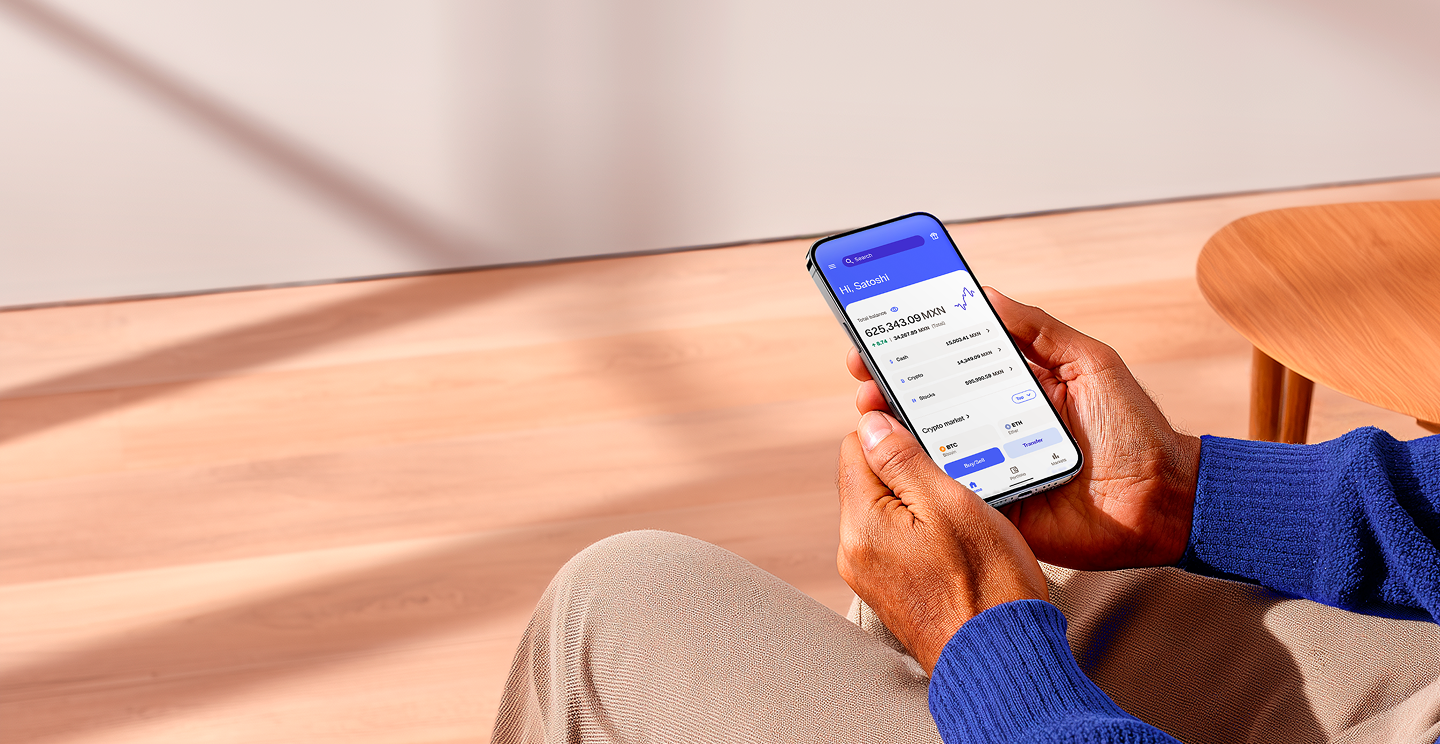 Official Bitso promotional photograph showing the investment app on a phone