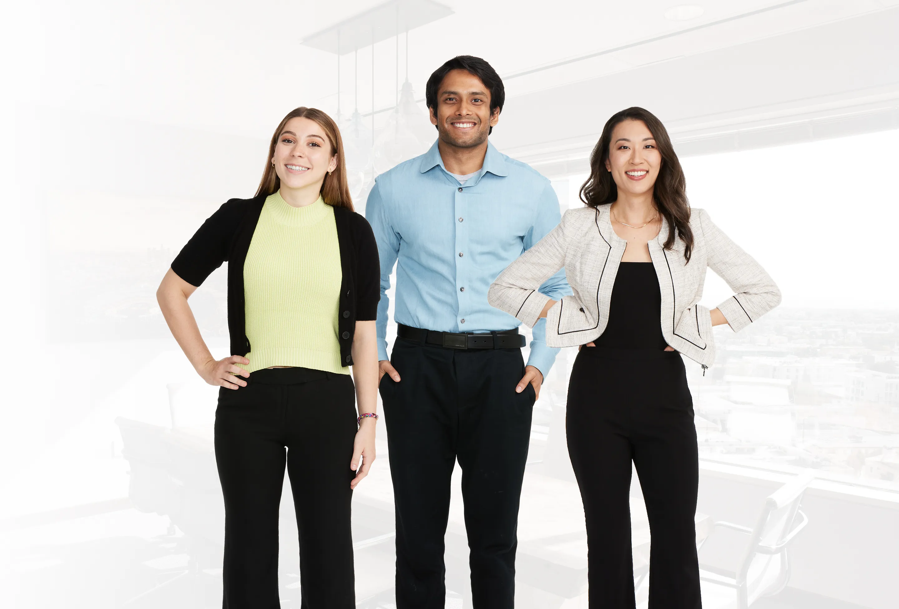 Three members of the Biz2Credit team standing in a modern office