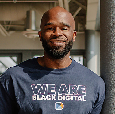 Black Digital founder Mike Utaegbulam wearing a We Are Black Digital shirt