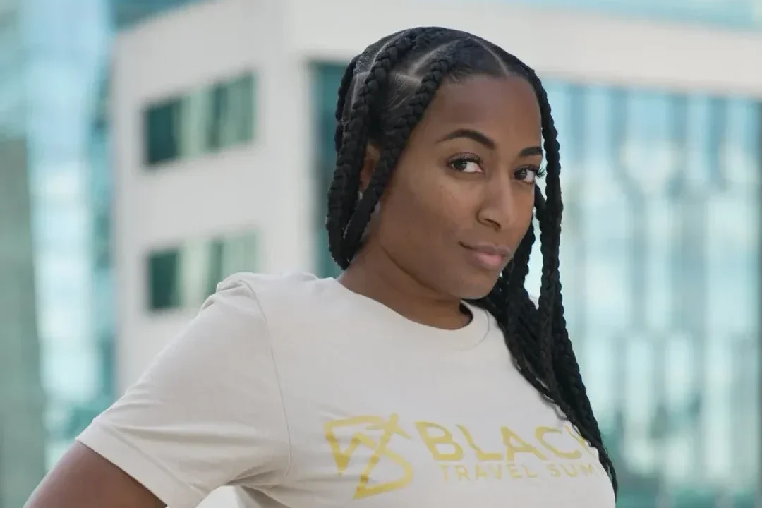 Black Travel Summit founder Anita Moreau wearing a company T-shirt