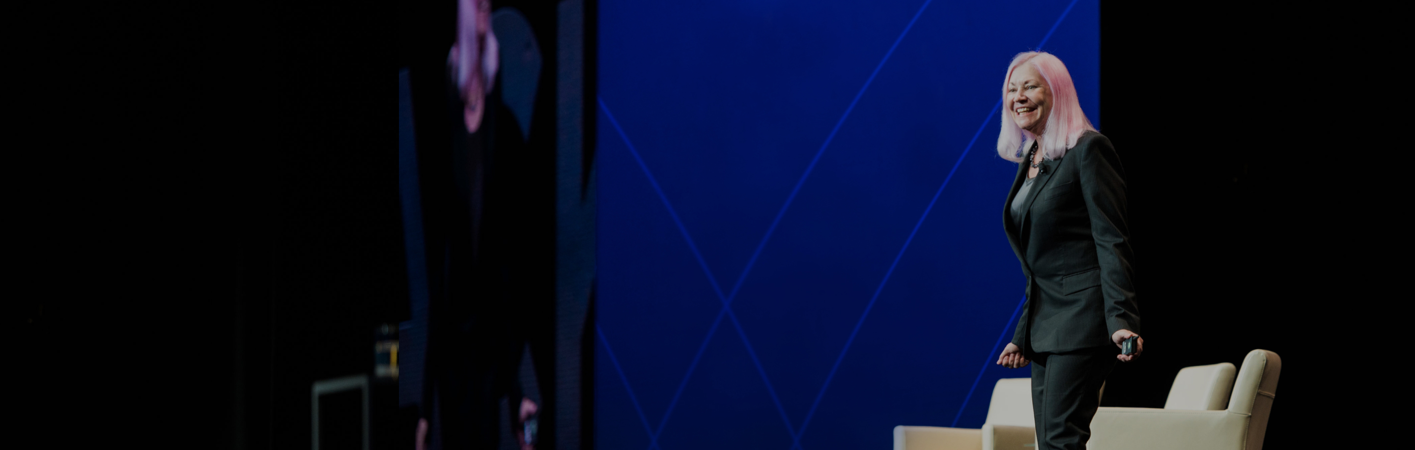 BlackLine founder Therese Tucker smiling onstage during a company event