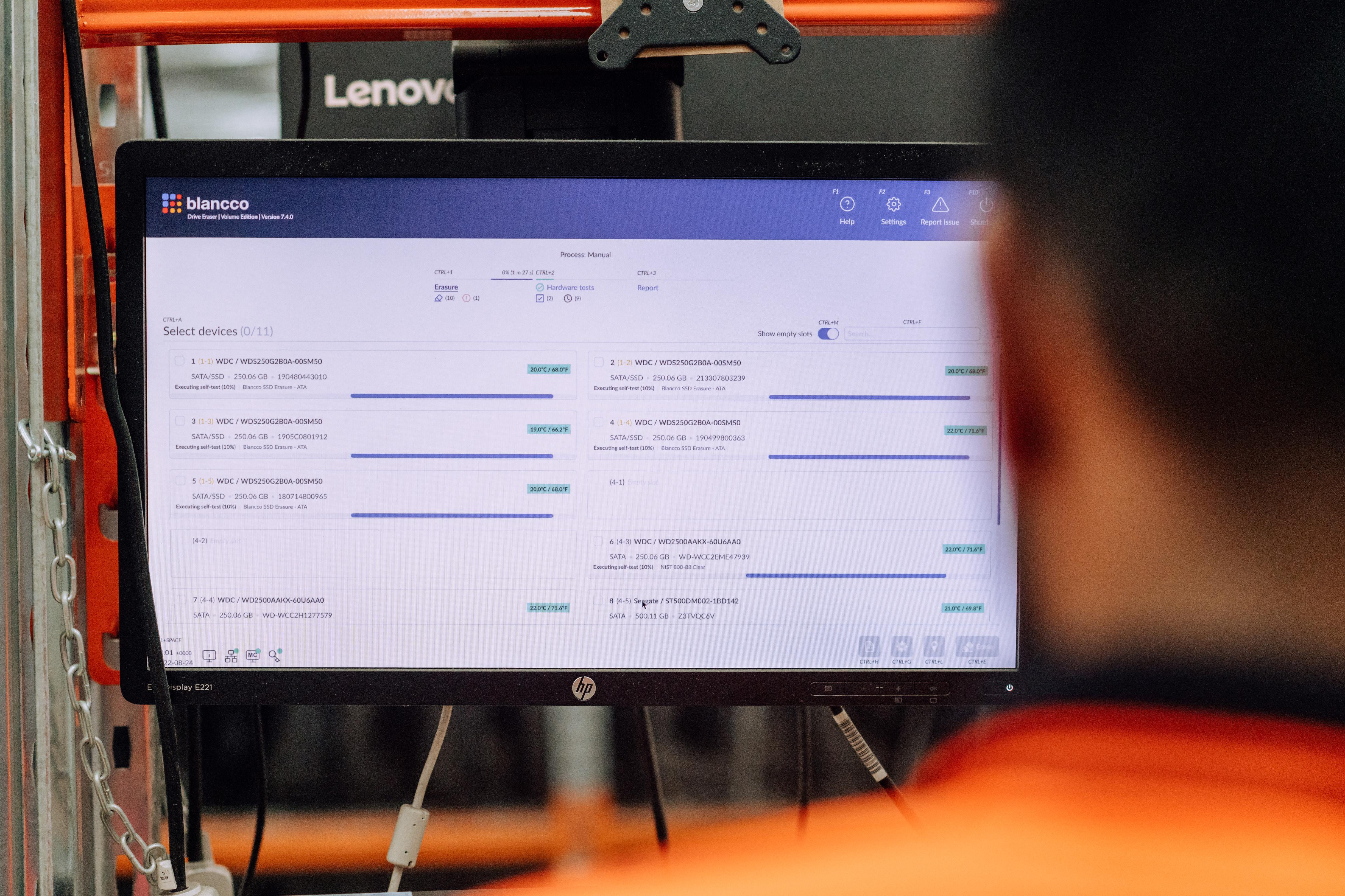 Blancco Drive Eraser displayed on a warehouse monitor, with several drives undergoing tests