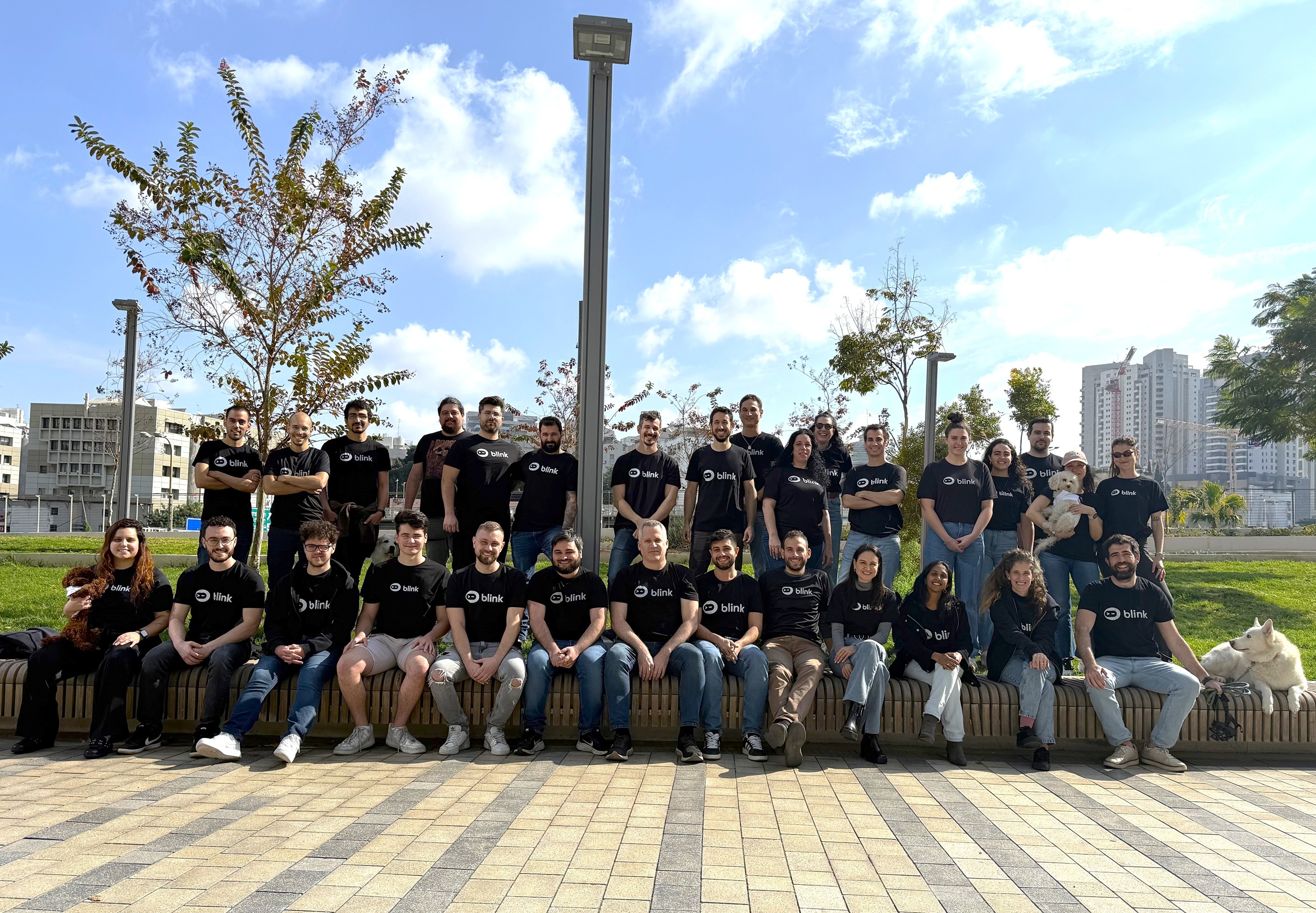 BlinkOps team gathered outdoors in matching company shirts