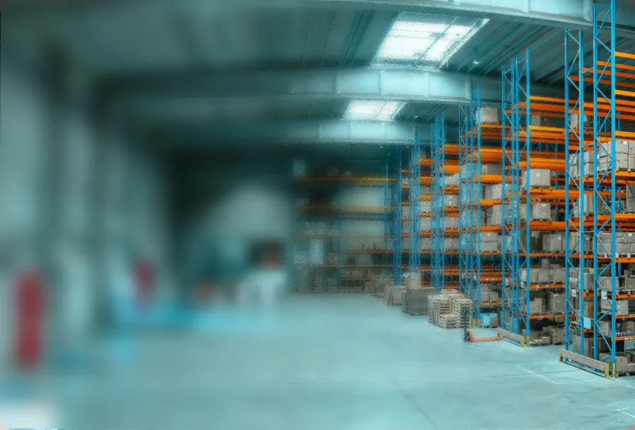 A modern warehouse with tall blue and orange storage racks
