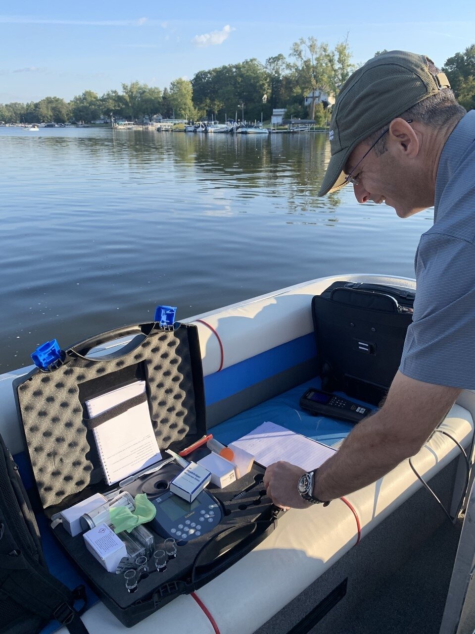 Moshe Harel checks testing equipment aboard a boat on Chippewa Lake