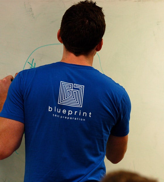 A Blueprint instructor teaching at a whiteboard in a company archive photograph