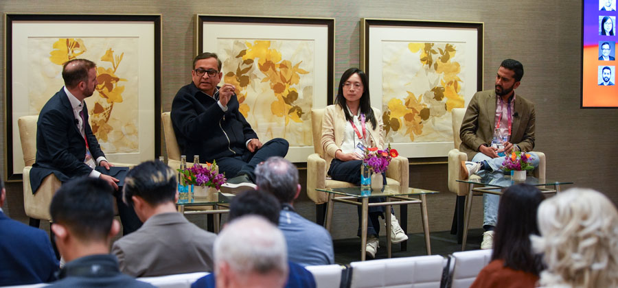 Bo Li, second from right, seated with fellow panelists at the 2026 Citi AI Summit