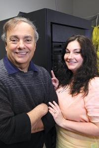 Bob Vormittag and his daughter Lisa beside a tall cabinet of computing equipment
