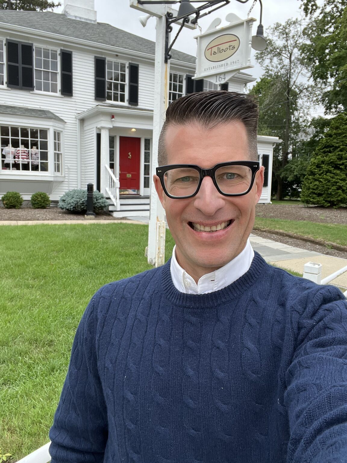Bobby Ferrario smiling outside the original Talbots store in Hingham, Massachusetts