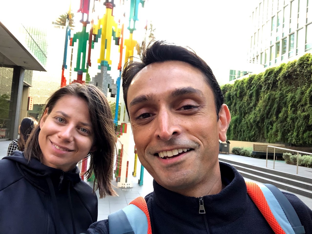 Natasha Todova and Bobby Mukherjee smiling together outdoors during their first in-person meeting