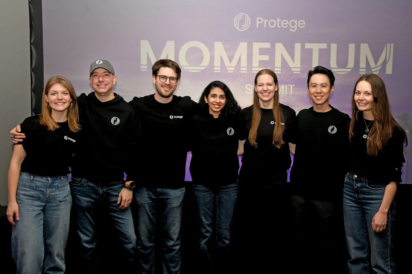 Bobby Samuels standing with Protege colleagues at a company gathering