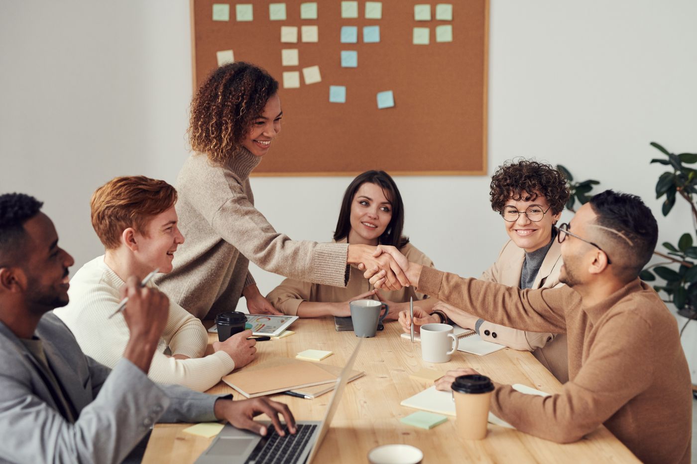 Illustrative photograph of colleagues meeting around a table