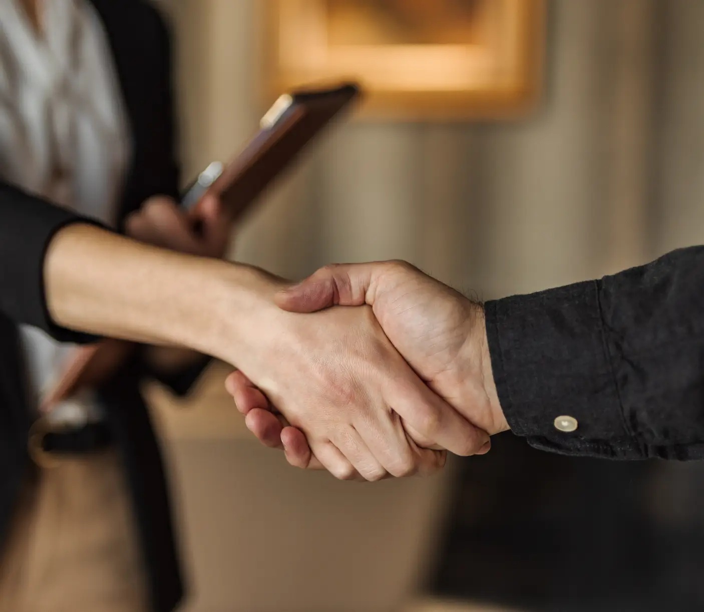Illustrative close-up of a handshake from Bold Penguin’s website
