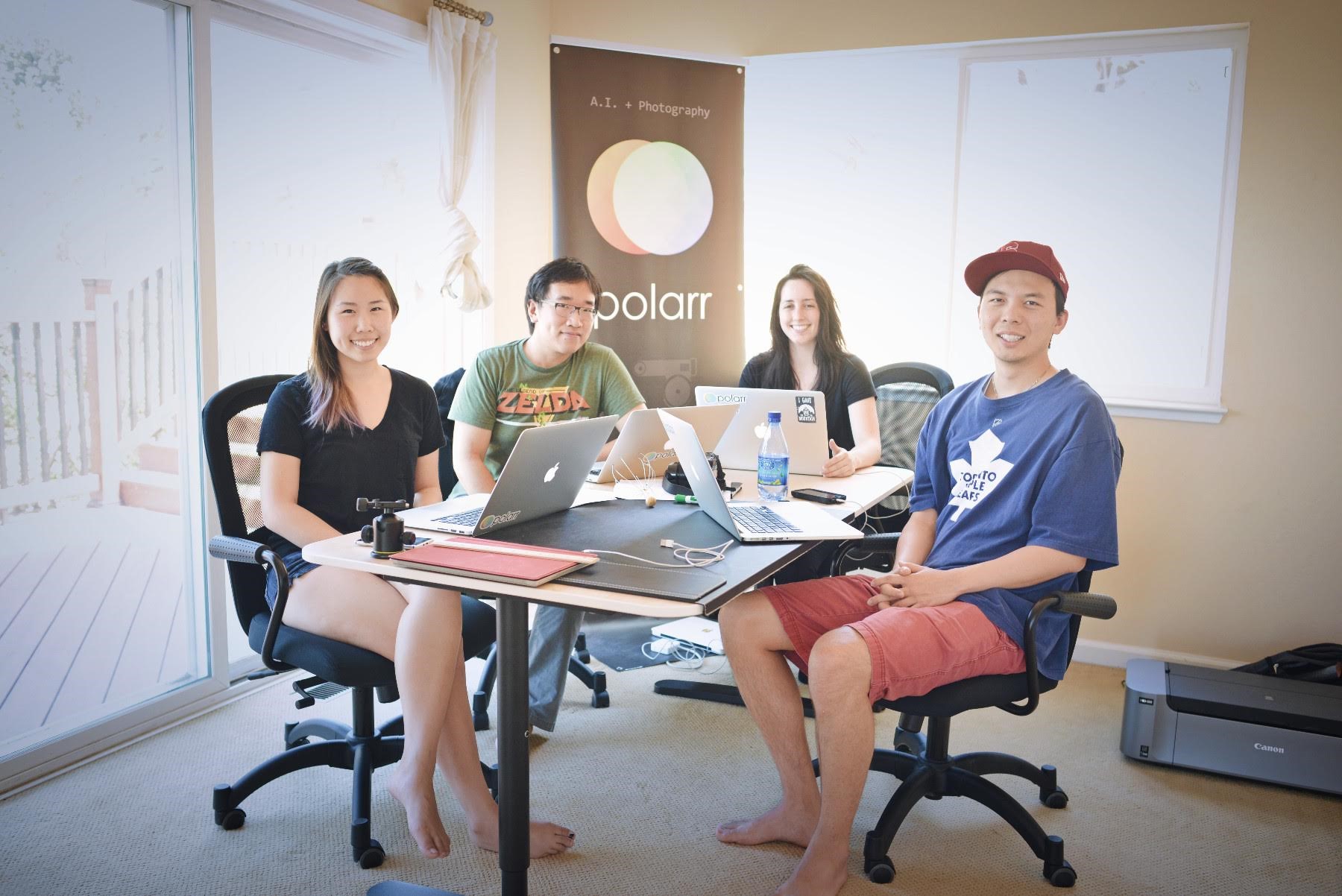 Early Polarr team seated around a table, with Borui Wang second from left