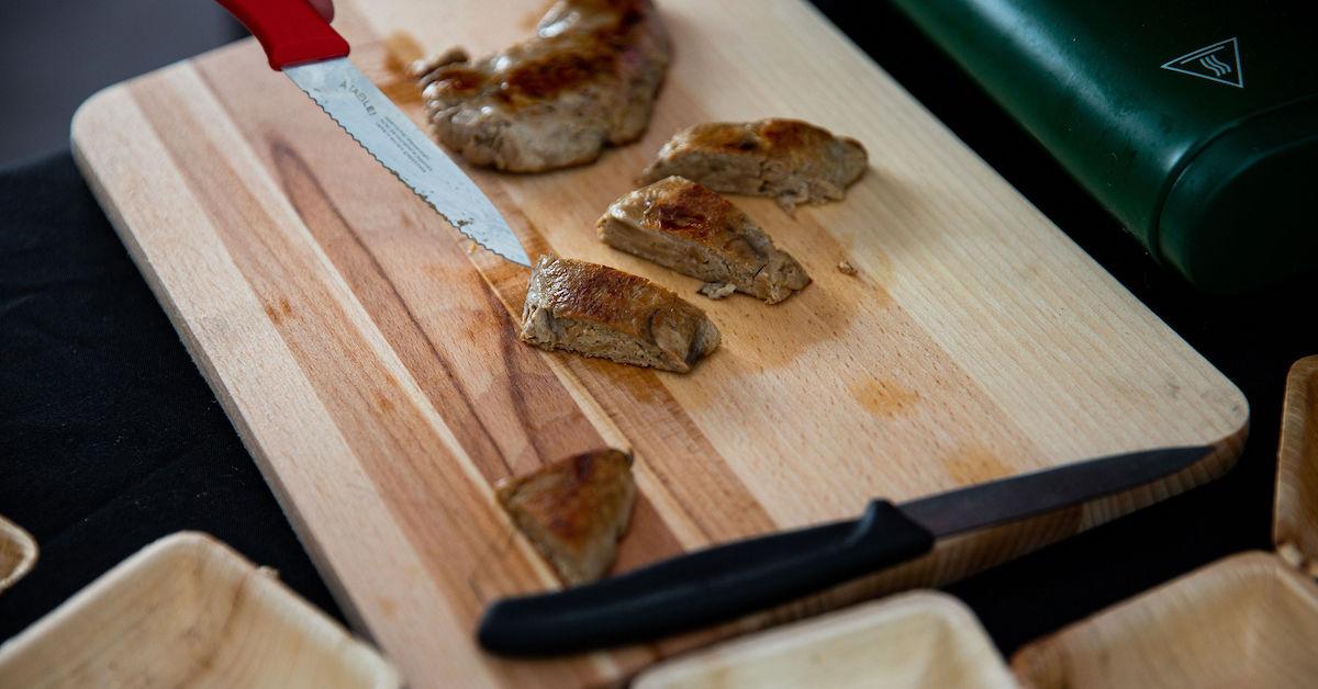 Sliced Bosque Foods mycelium chicken-style prototype on a wooden board