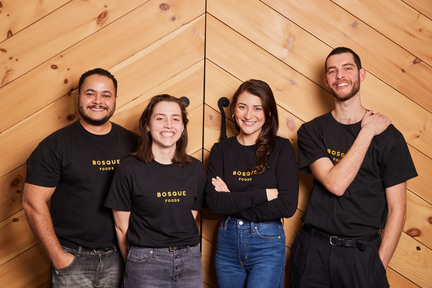 Four Bosque Foods team members wearing company shirts