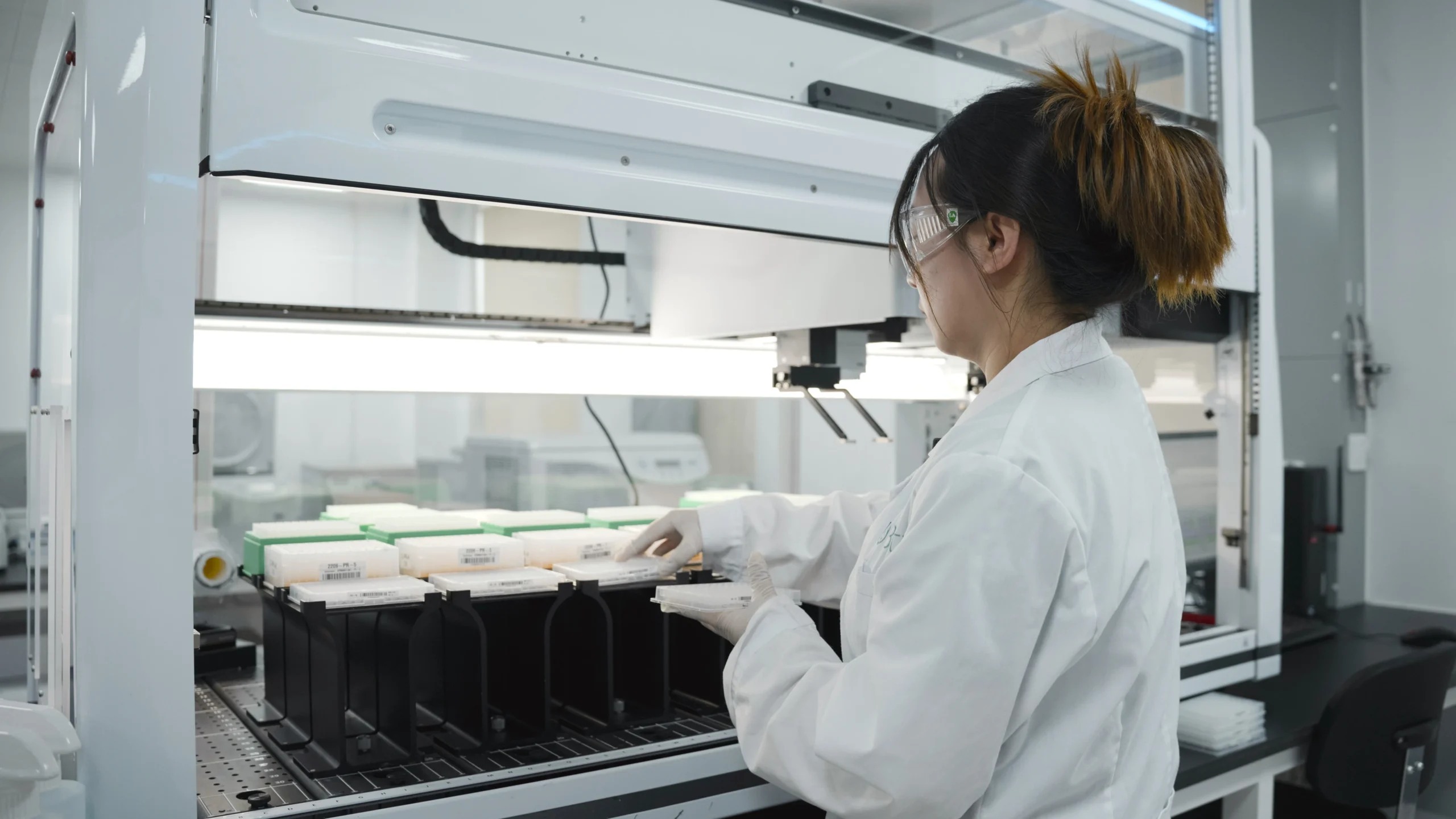 Researcher working with laboratory automation equipment at Bota Biosciences