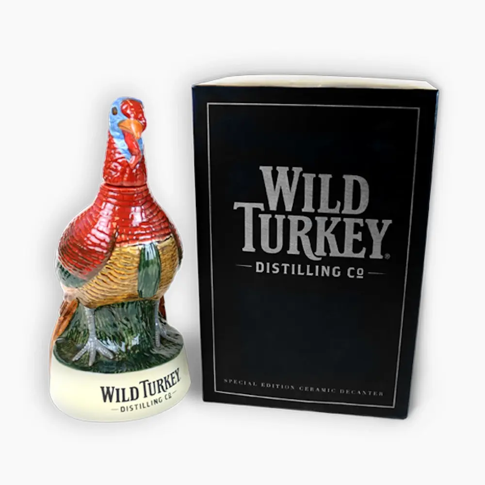 Hand-painted turkey-shaped Wild Turkey decanter beside its black presentation box