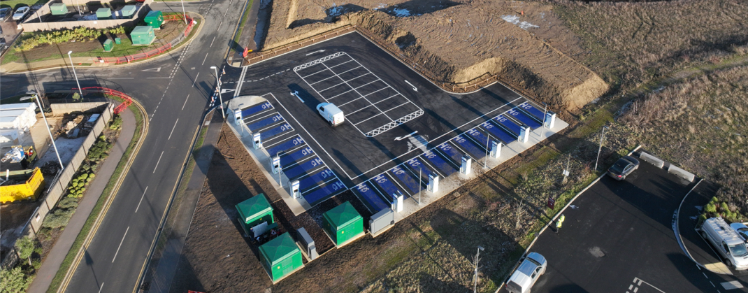 An aerial photograph of a bp pulse charging site with marked bays and electrical equipment.