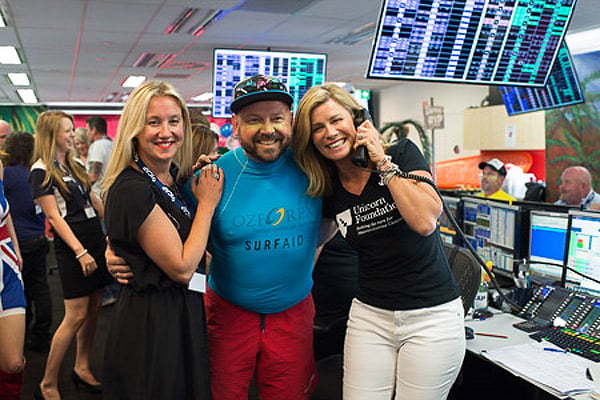 Guests beside telephones and market screens at ICAP's Sydney charity day in December 2014