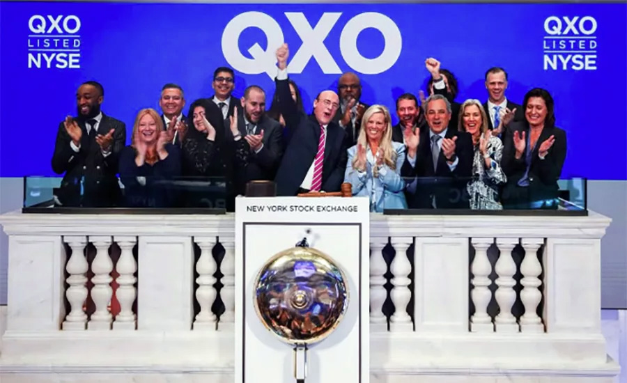 Brad Jacobs raises a fist alongside QXO colleagues at the New York Stock Exchange in 2025