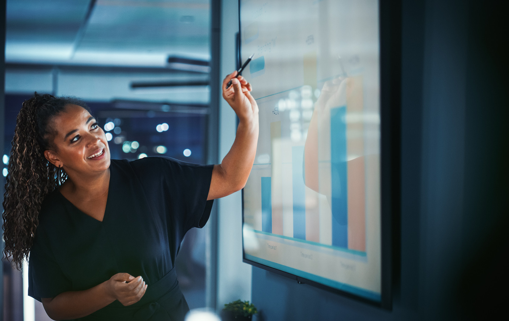 A professional presenting financial charts on a glass display