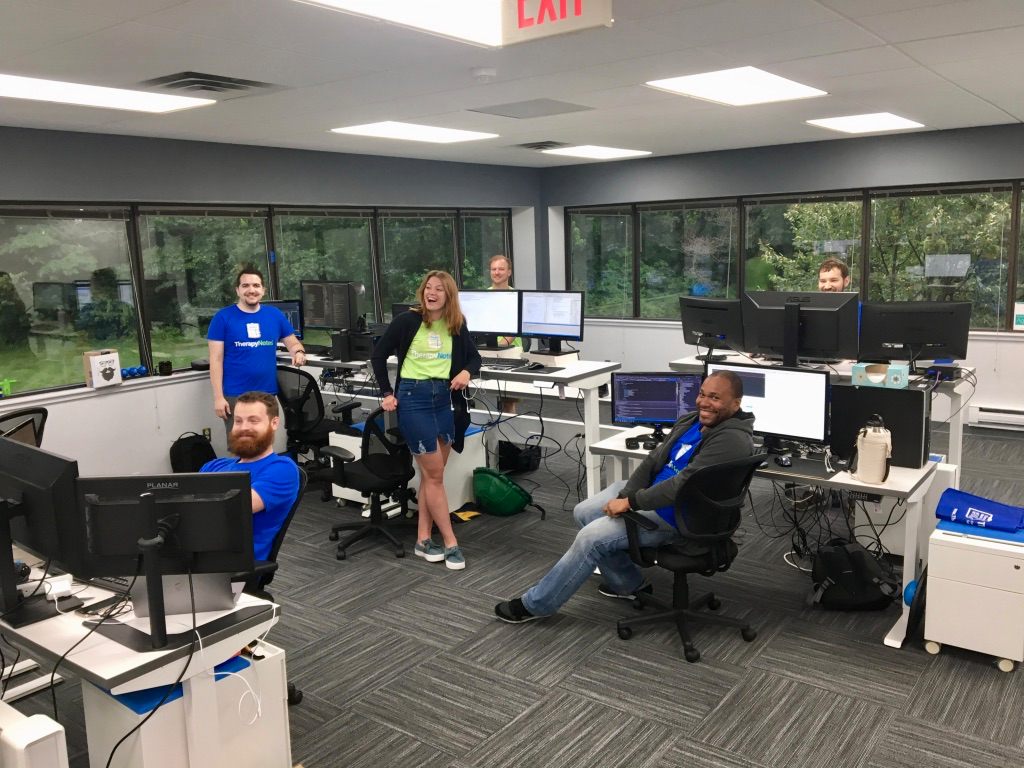 Developers working at adjustable desks in the TherapyNotes office