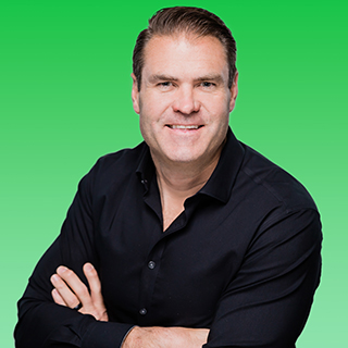 Brad Rinklin in a black shirt, photographed against a bright green background