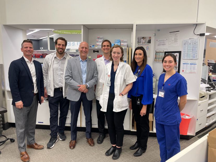 Brad Ulrich, third from left, with six colleagues during his West Lafayette Walgreens visit