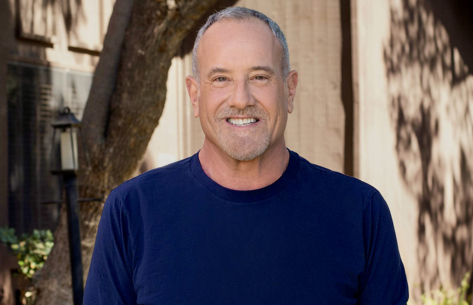 BNC founder Howard Bragman smiling outdoors in a navy shirt