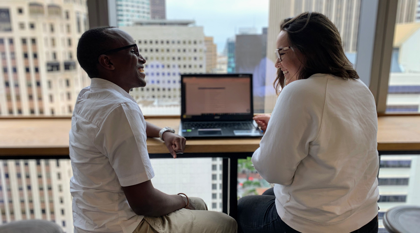 Two Branch colleagues talking beside a laptop in an office