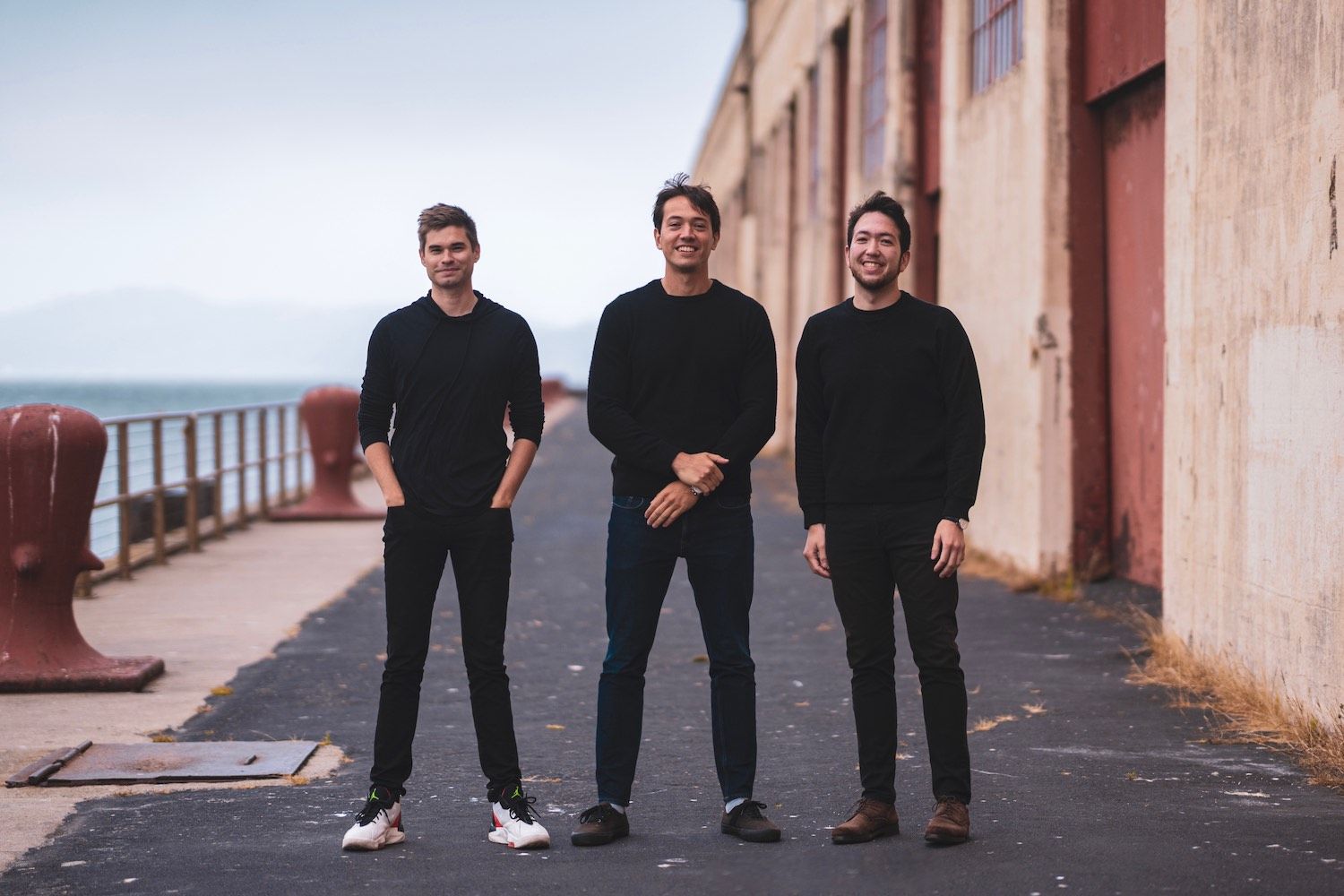 Phantom co-founders Chris Kalani, Francesco Agosti and Brandon Millman standing together by the waterfront