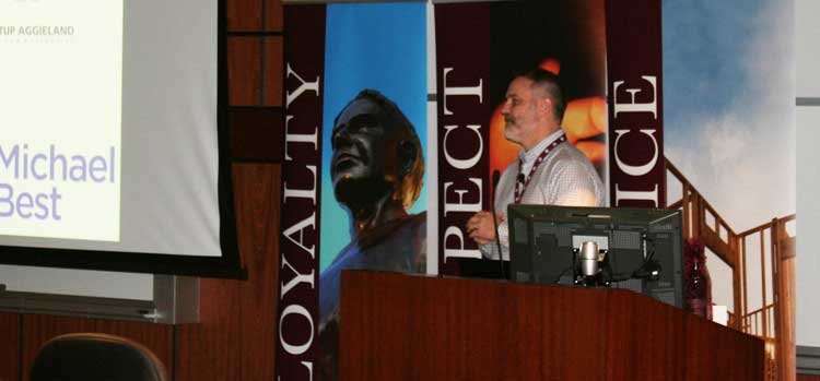 Branndon Stewart speaking at a lectern at Aggie Entrepreneurship Saturday in Round Rock in January 2017
