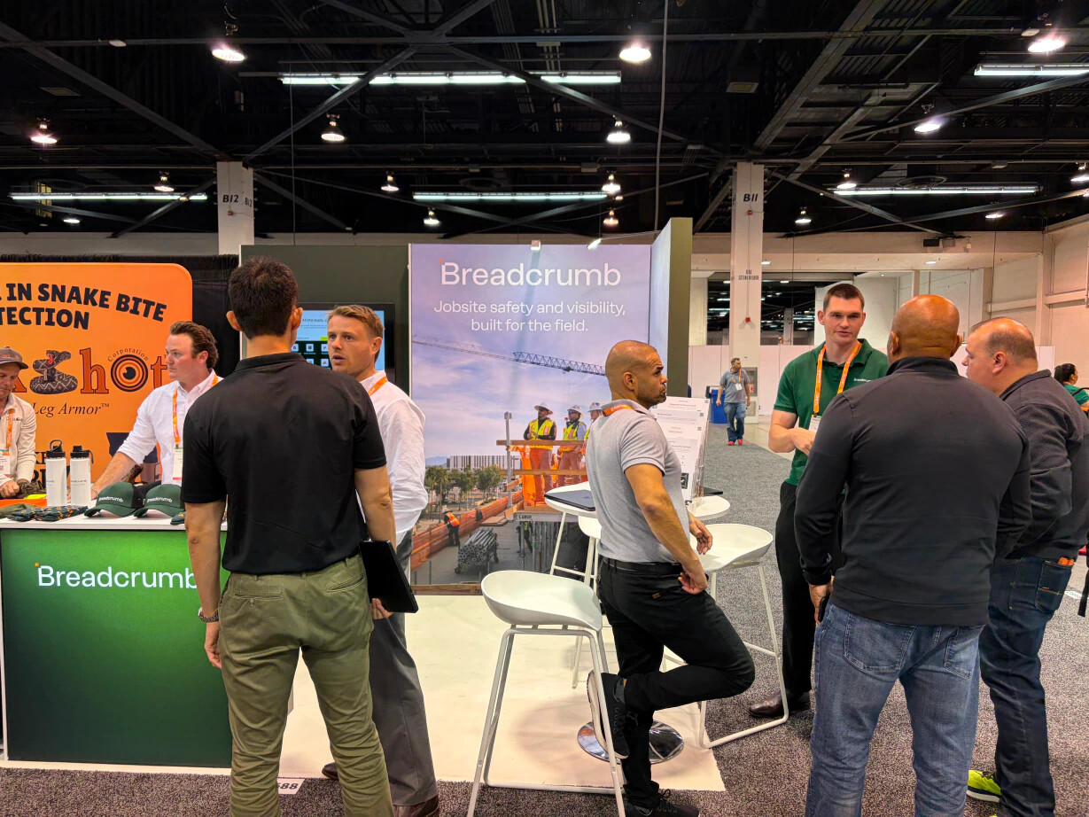Breadcrumb team members speaking with construction professionals at a trade event