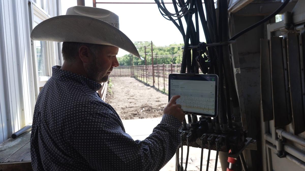 Joe Epperly working with a tablet in Breedr’s NextGen Cattle Co. case study