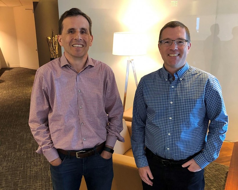 Sandy Bird and Brendan Hannigan standing together in an office