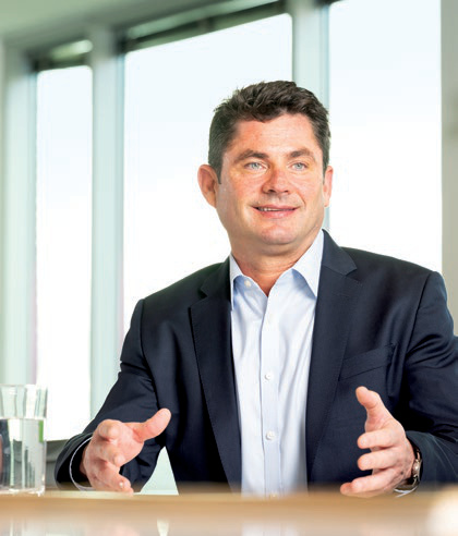 Brendan Horgan seated at a table, gesturing during a conversation