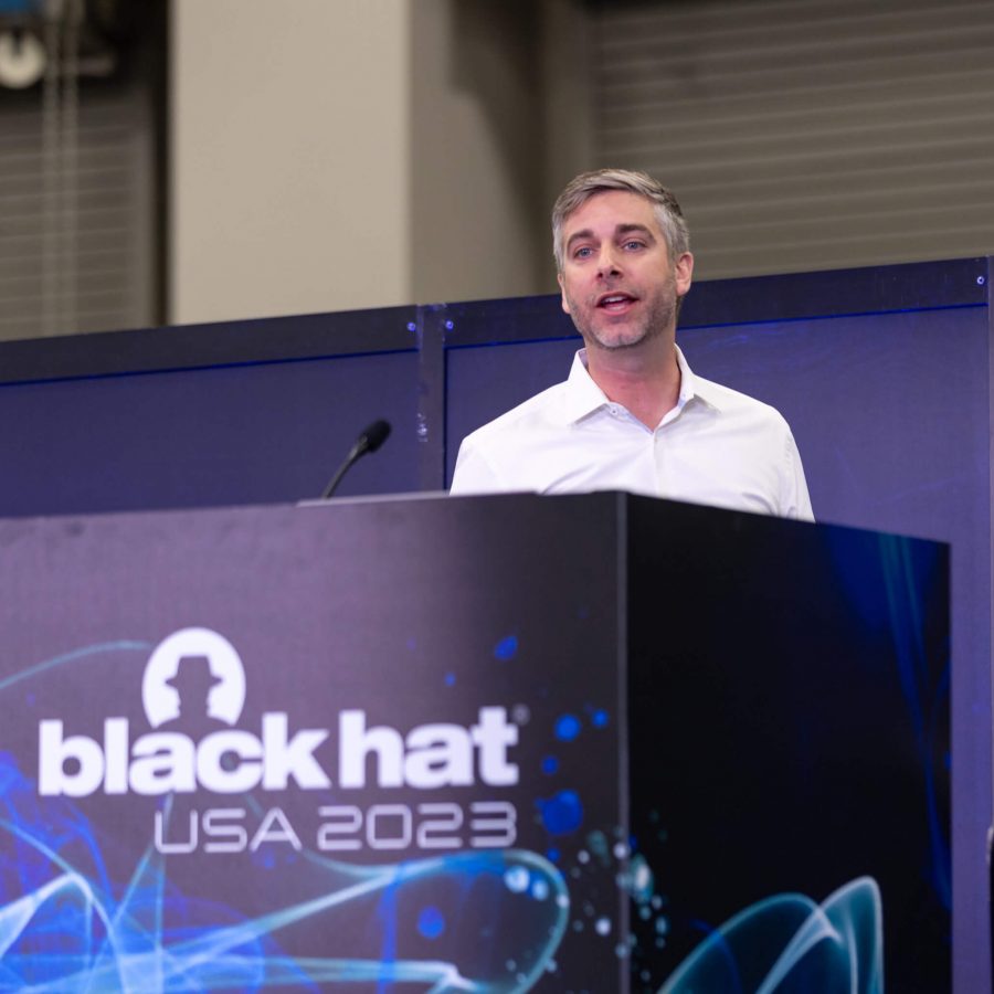 Brendan O’Connor speaking behind a lectern at Black Hat USA 2023