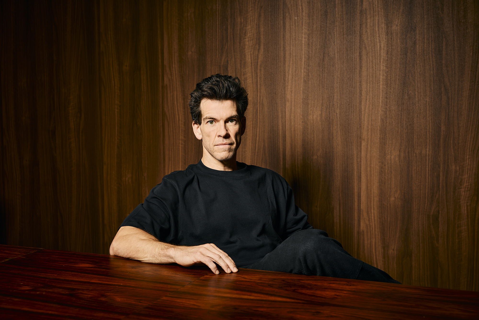 Brendan Wallace seated at a wooden table in Fifth Wall’s Beverly Hills office